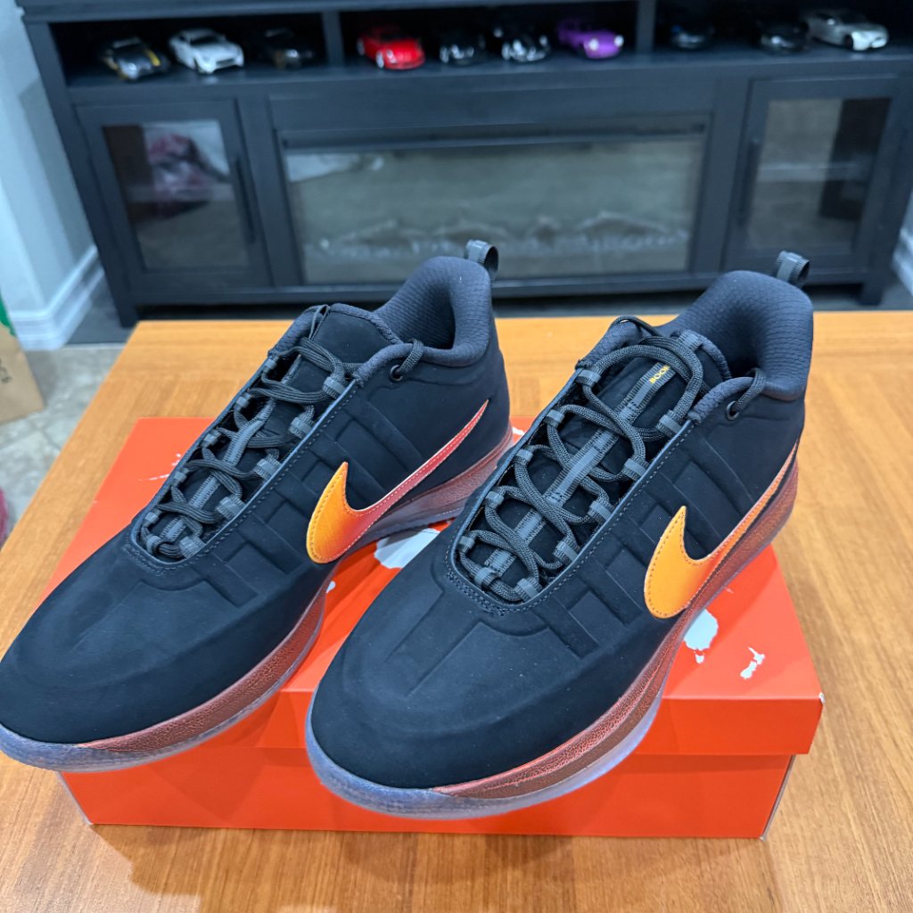 Nike Black Sneakers With Orange Swoosh And Brownish Midsole